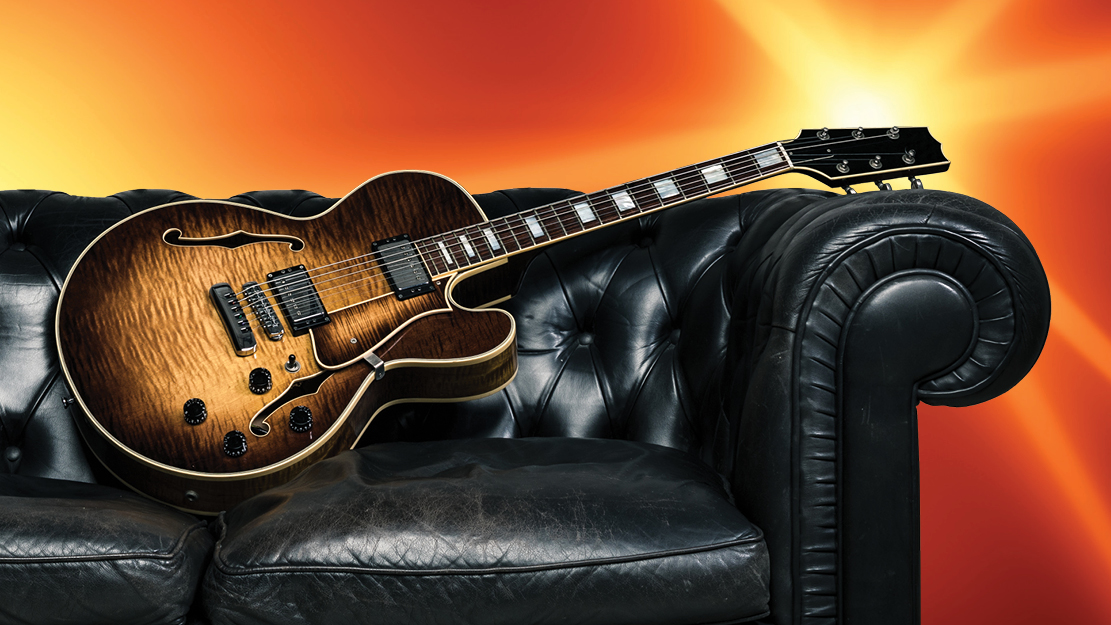 Until we meet again, here's something to watch together at home Guitar rests on a couch with lights behind it
