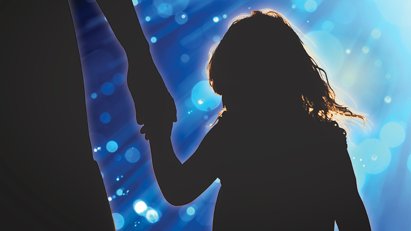 Sharing is caring Child holds hand of an adult at a concert