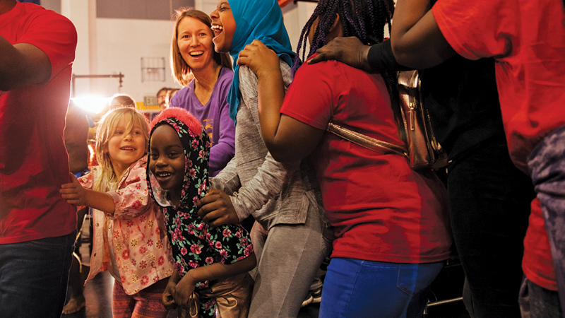 Participants dance together at The Global Village Experience