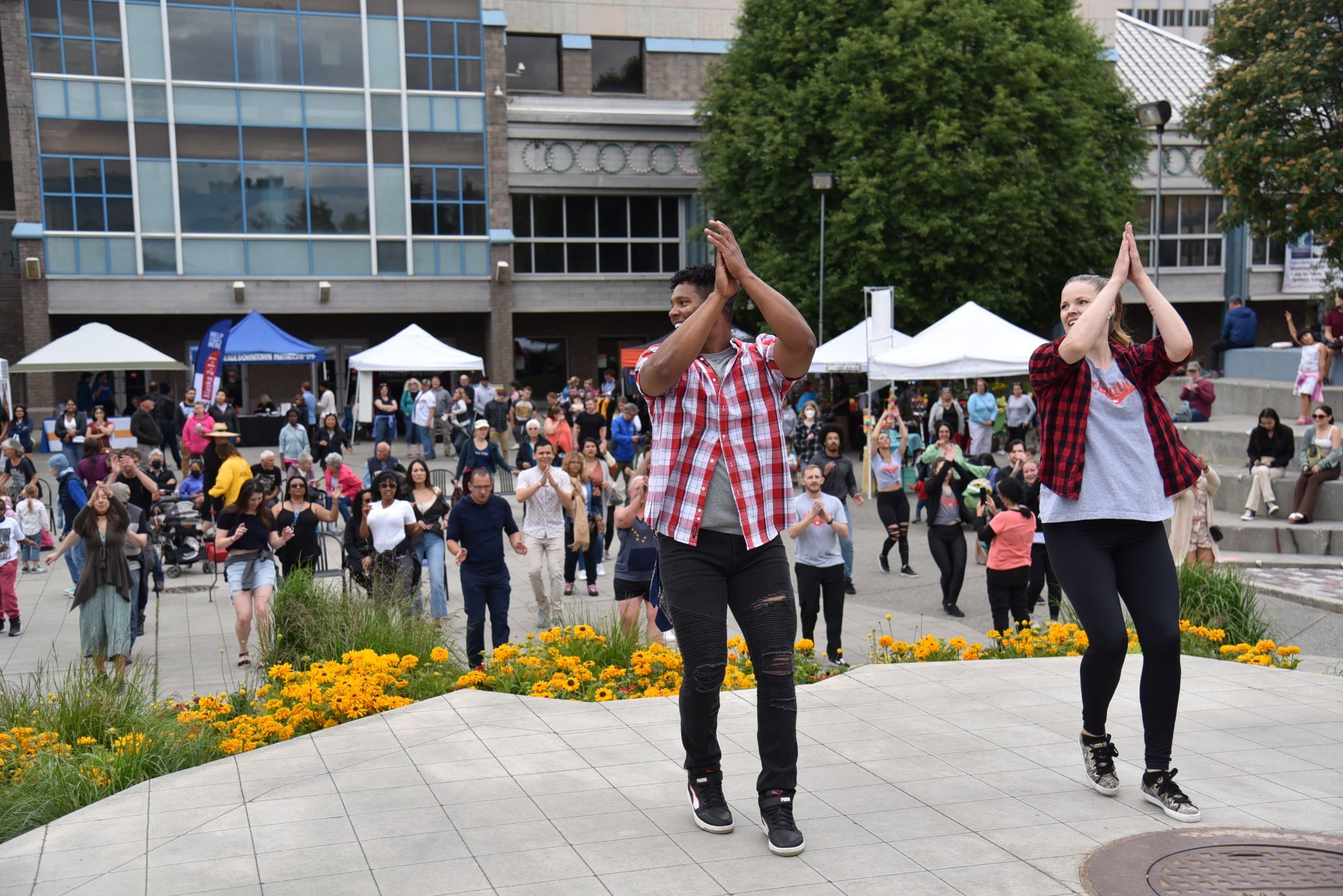 Anaya Latin Dance duo Ciro and Liz Anaya happily lead community members in an outdoor Cuban dance workshop